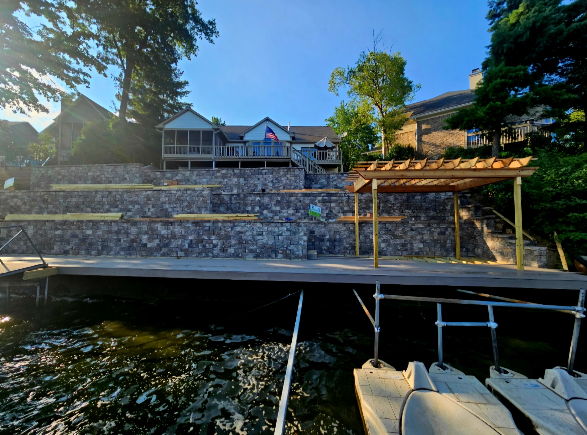 Dock, seawall and pergola on Morse Reservoir by LA Landscapes Inc